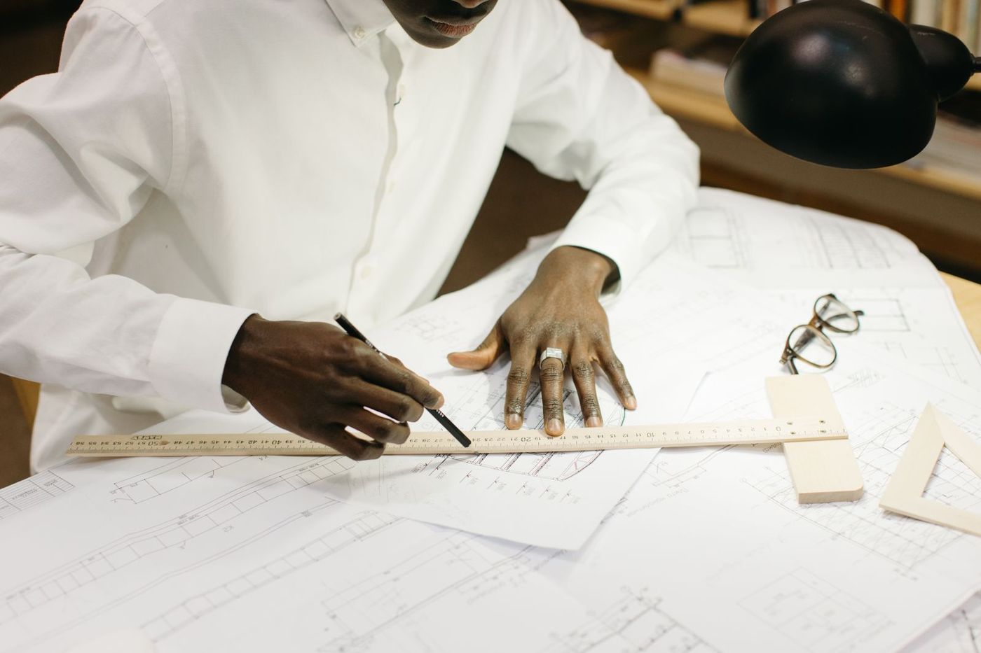Hands at the drafting desk