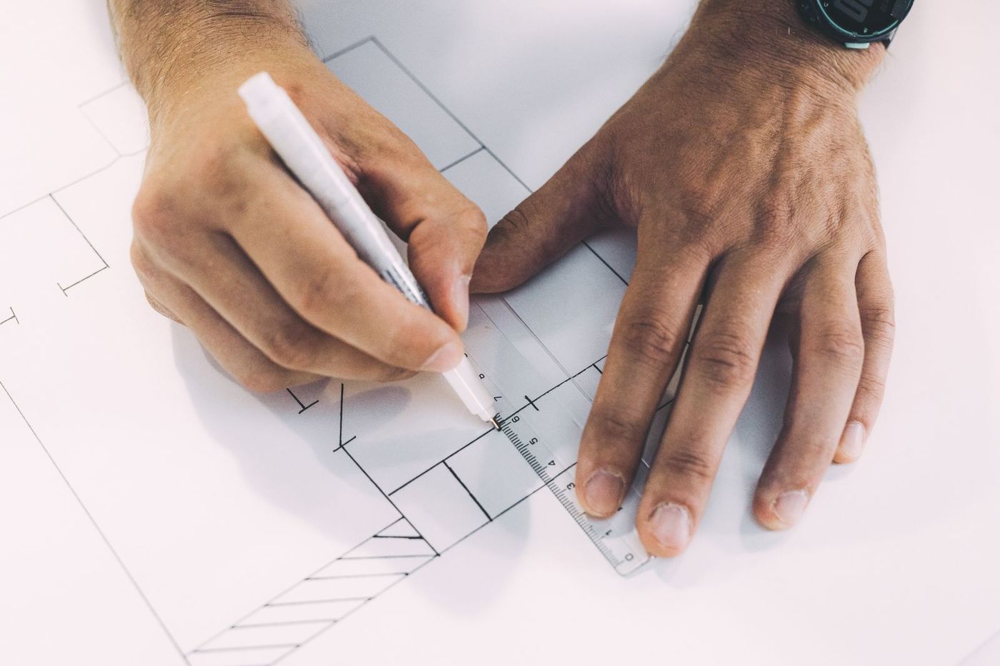 Hands sketching a plan